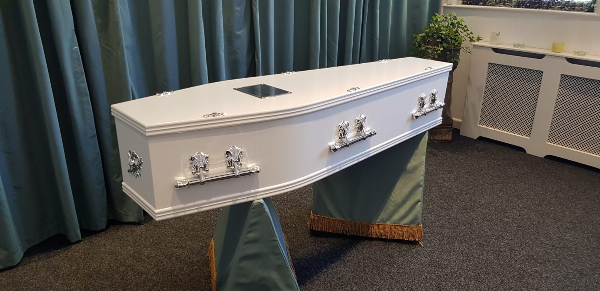 A selection of white coffins at Jason O'Brien & Family Funeral Services Limited in Ashton-Under-Lyne, Greater Manchester